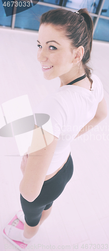 Image of happy diet concept with young woman on pink scale