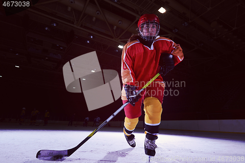 Image of teen ice hockey player in action