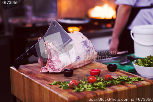 Image of chef cutting big piece of beef