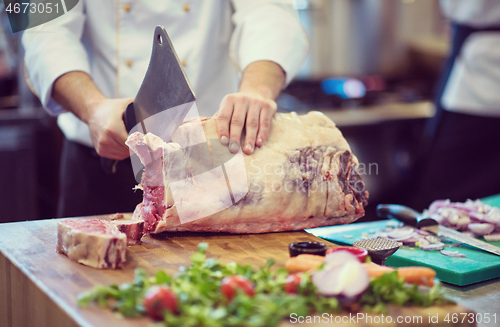 Image of chef cutting big piece of beef