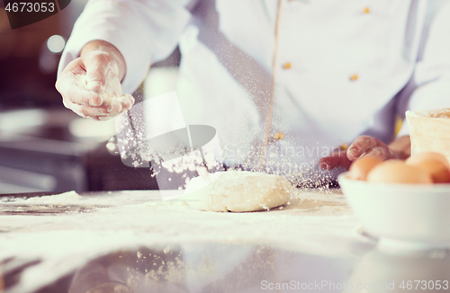 Image of chef hands preparing dough for pizza