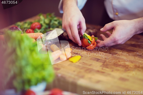 Image of closeup of Chef hands preparing beef steak