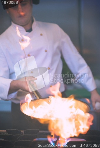 Image of Chef doing flambe on food