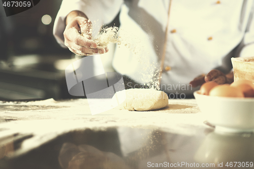 Image of chef hands preparing dough for pizza