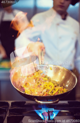 Image of Chef doing flambe on food