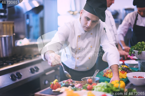 Image of Chef finishing steak meat plate