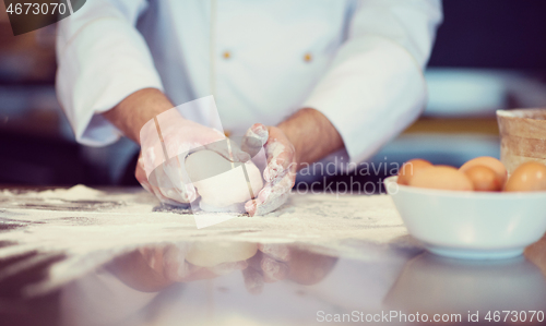 Image of chef hands preparing dough for pizza