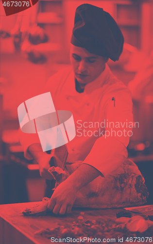 Image of chef cutting big piece of beef
