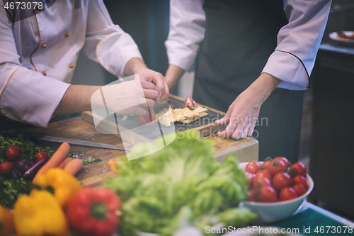 Image of team cooks and chefs preparing meal