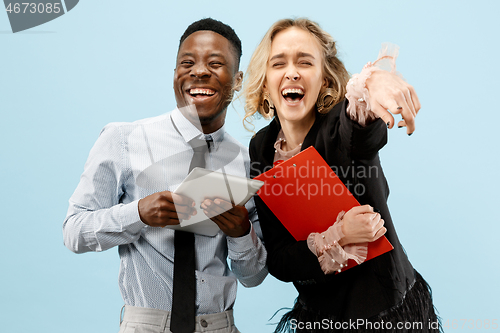 Image of Concept of partnership in business. Young man and woman standing at studio