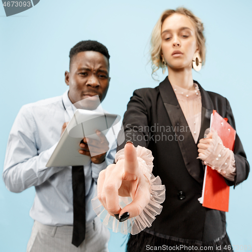 Image of Woman\'s hand with finger on blue background