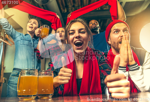 Image of Sport, people, leisure, friendship and entertainment concept - happy football fans or male friends drinking beer and celebrating victory at bar or pub