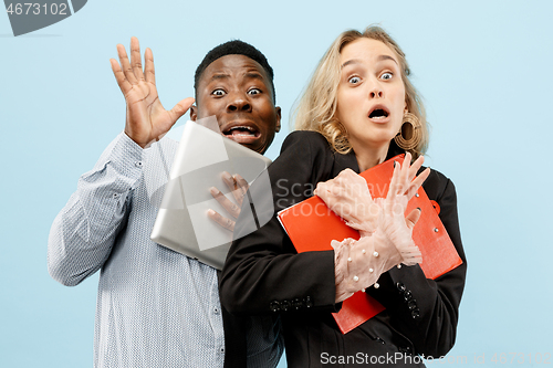 Image of We are afraid. Fright. Portrait of the scared mixed couple.