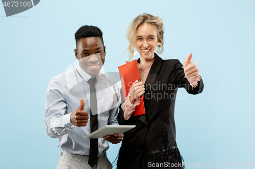 Image of Concept of partnership in business. Young man and woman standing at studio