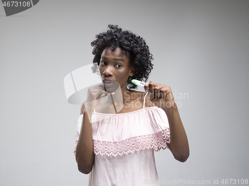 Image of young woman looking on pregnancy test