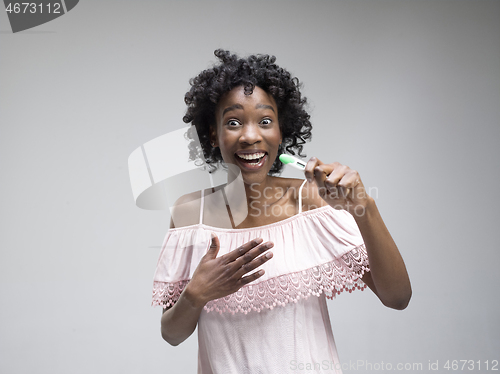 Image of Smiling young woman looking on pregnancy test