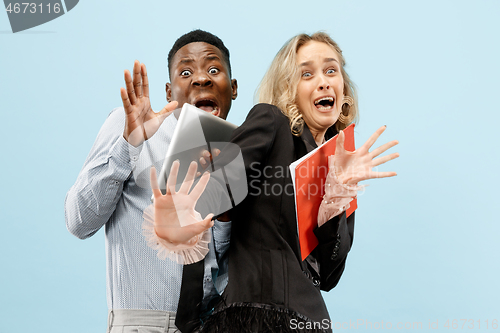 Image of We are afraid. Fright. Portrait of the scared mixed couple.