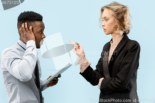 Image of Serious businesswoman and colleague in the office.