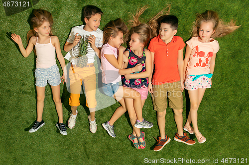 Image of Group of happy children playing outdoors.