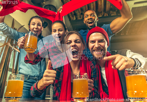 Image of Sport, people, leisure, friendship and entertainment concept - happy football fans or male friends drinking beer and celebrating victory at bar or pub