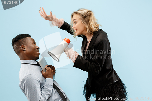 Image of angry businesswoman and colleague in the office.