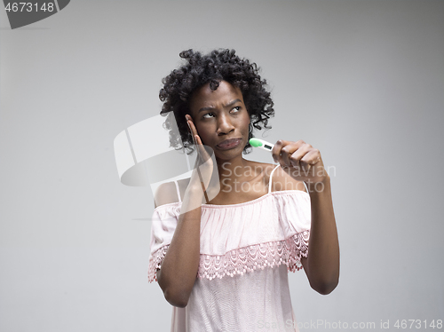 Image of young woman looking on pregnancy test