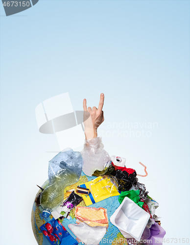 Image of A globe of the earth with trash over white background, the concept of ecology problem