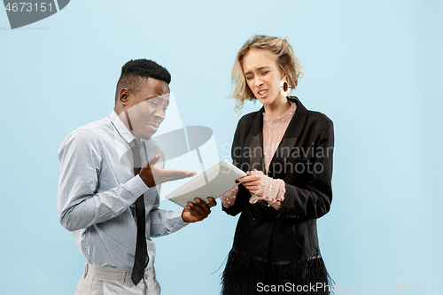 Image of Serious businesswoman and colleague in the office.