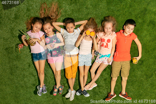 Image of Group of happy children playing outdoors.