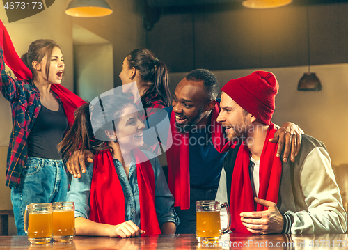 Image of Sport, people, leisure, friendship and entertainment concept - happy football fans or male friends drinking beer and celebrating victory at bar or pub