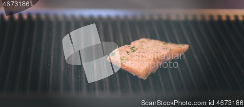 Image of Salmon fillets cooking on grill