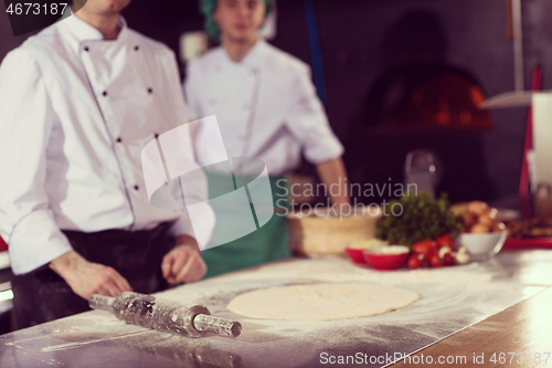 Image of chef preparing dough for pizza