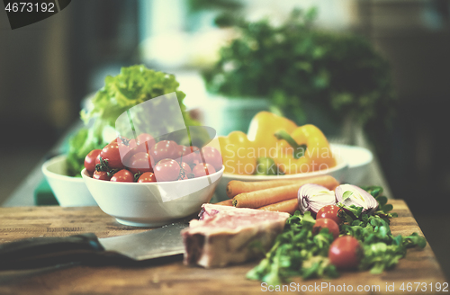 Image of Juicy slice of raw steak on wooden table