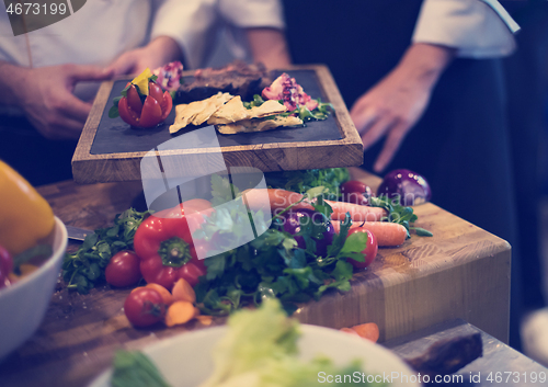 Image of team cooks and chefs preparing meal