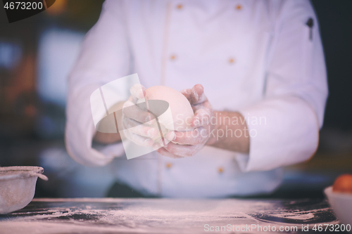 Image of chef hands preparing dough for pizza