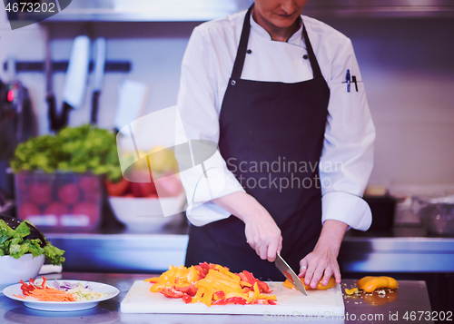 Image of Chef cutting fresh and delicious vegetables