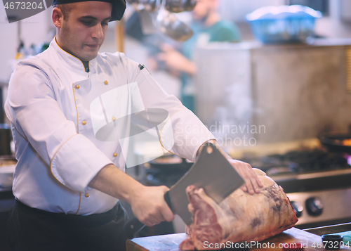 Image of chef cutting big piece of beef