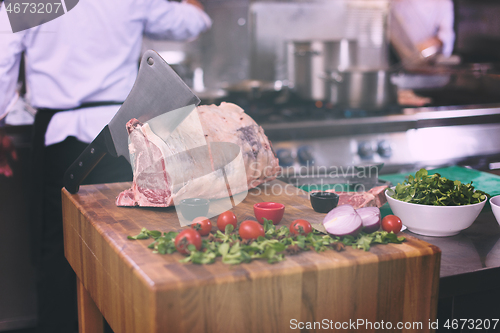 Image of chef cutting big piece of beef