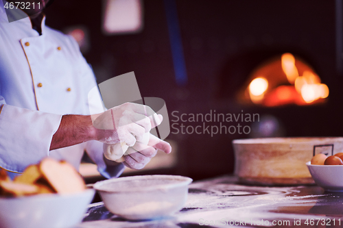 Image of chef hands preparing dough for pizza