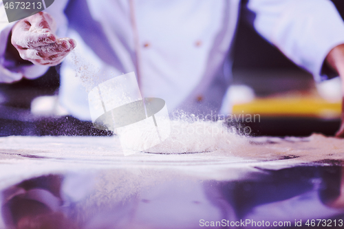 Image of chef hands preparing dough for pizza