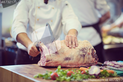 Image of chef cutting big piece of beef