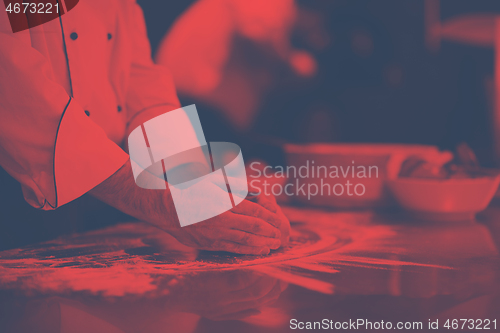 Image of chef hands preparing dough for pizza