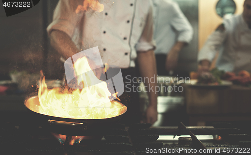 Image of Chef doing flambe on food