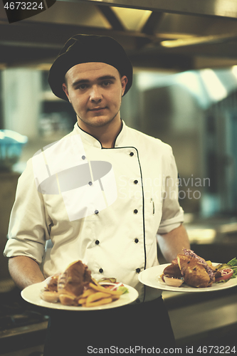 Image of Chef showing dishes of tasty meals