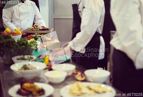 Image of team cooks and chefs preparing meal