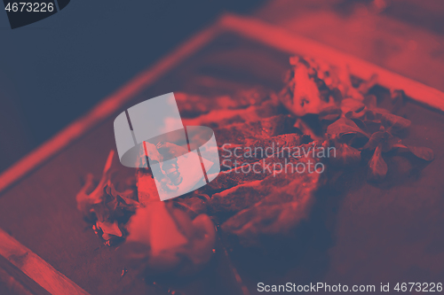 Image of Juicy slices of grilled steak on wooden board