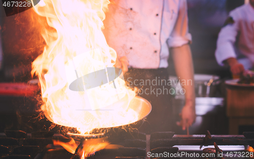 Image of Chef doing flambe on food