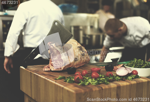 Image of chef cutting big piece of beef