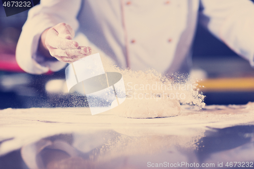 Image of chef hands preparing dough for pizza