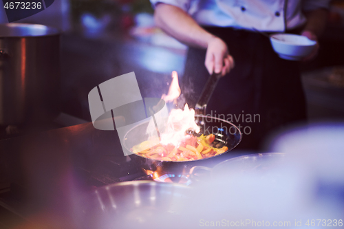 Image of Chef doing flambe on food